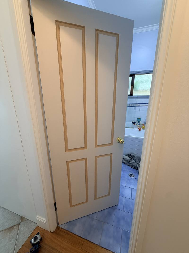 Before: custom door hung with raw, unpainted panel edges